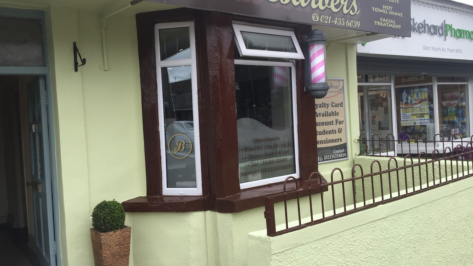 The Berkat Barbers shopfront on Skehard Road, Blackrock, Cork, with the barber pole and bay window